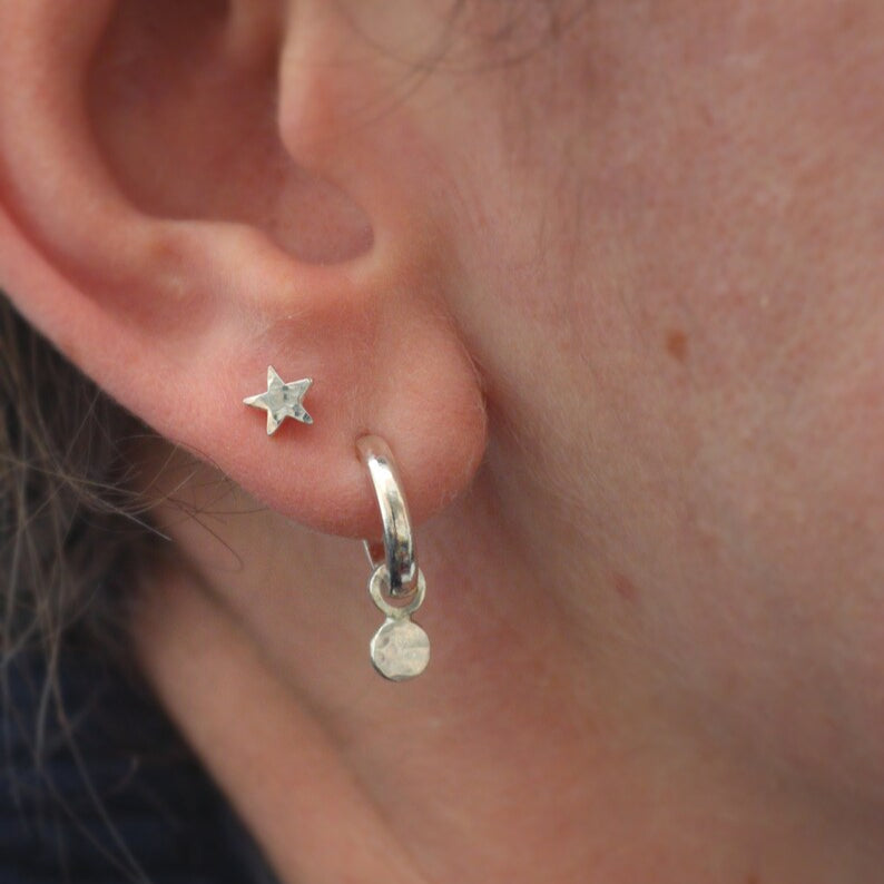 Tiny star studs worn in a second piercing next to my confetti hoops.