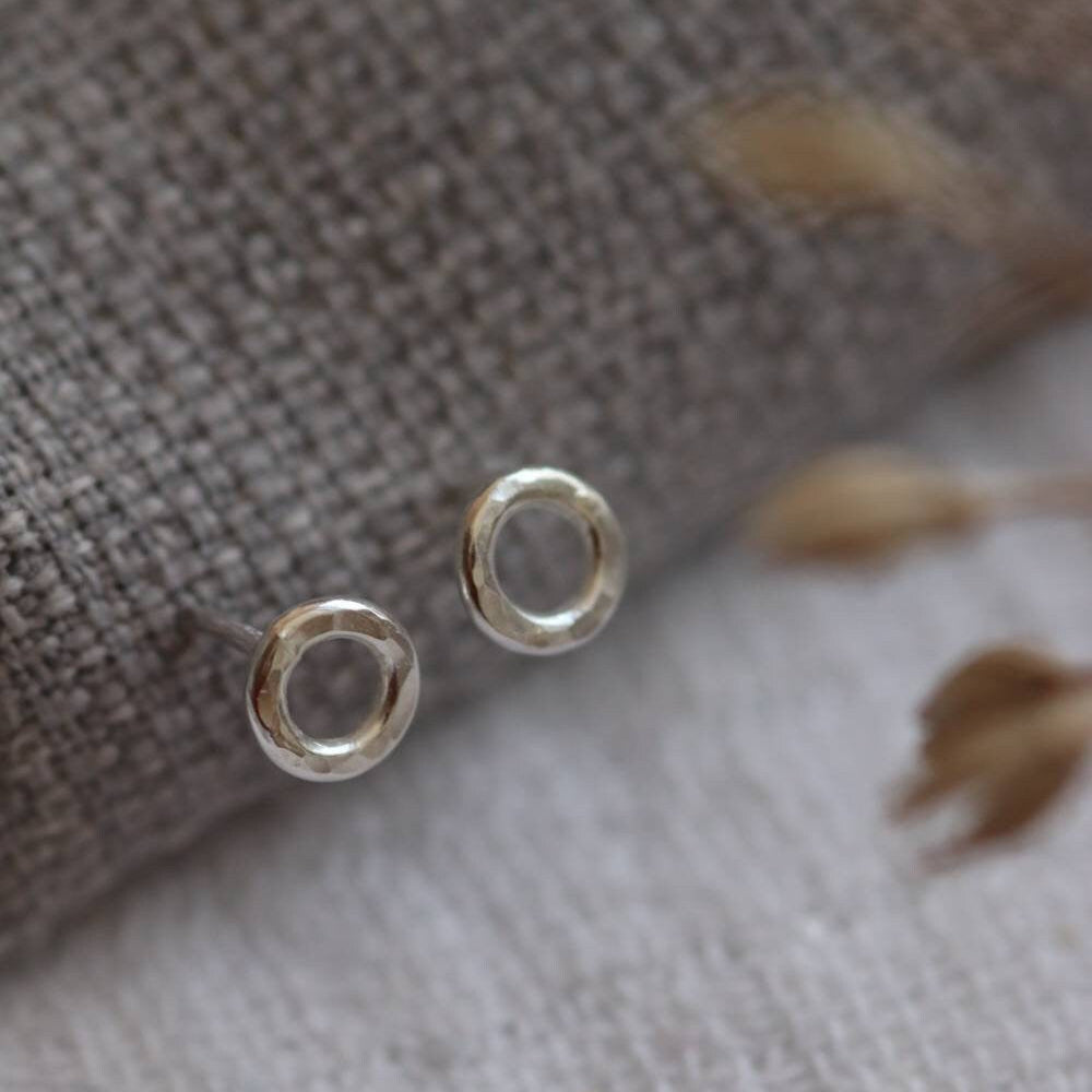 silver circle studs with a hammered texture.