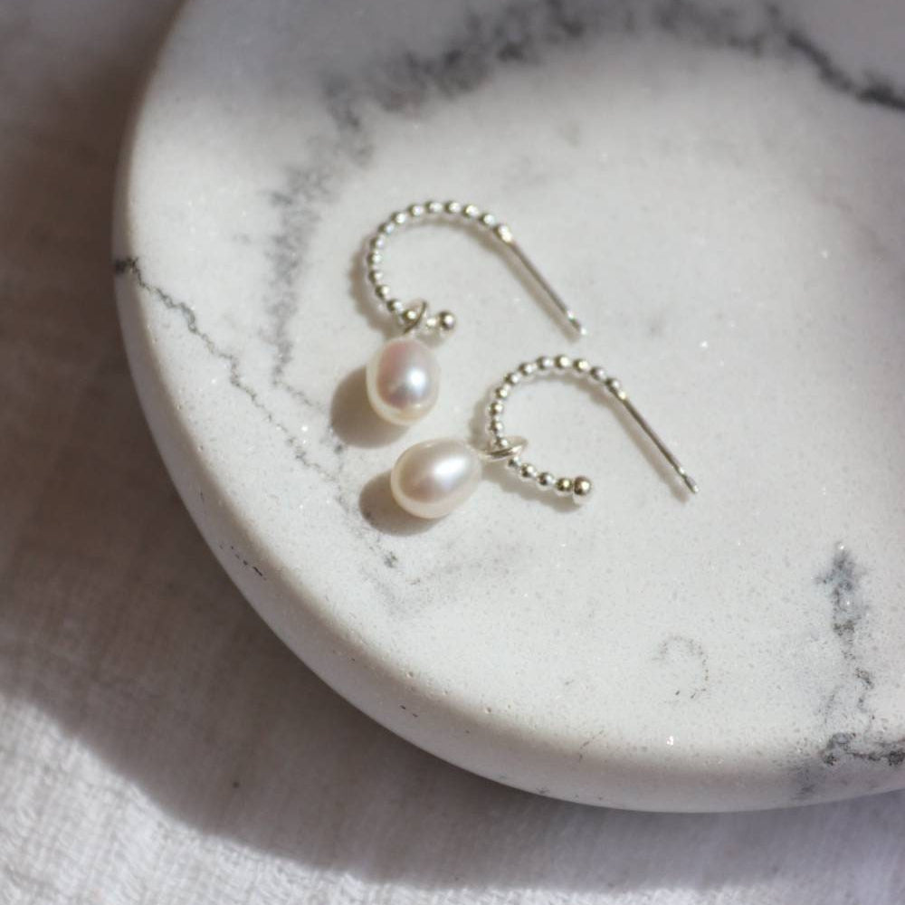 Small silver beaded design hoops with small pearl drops.