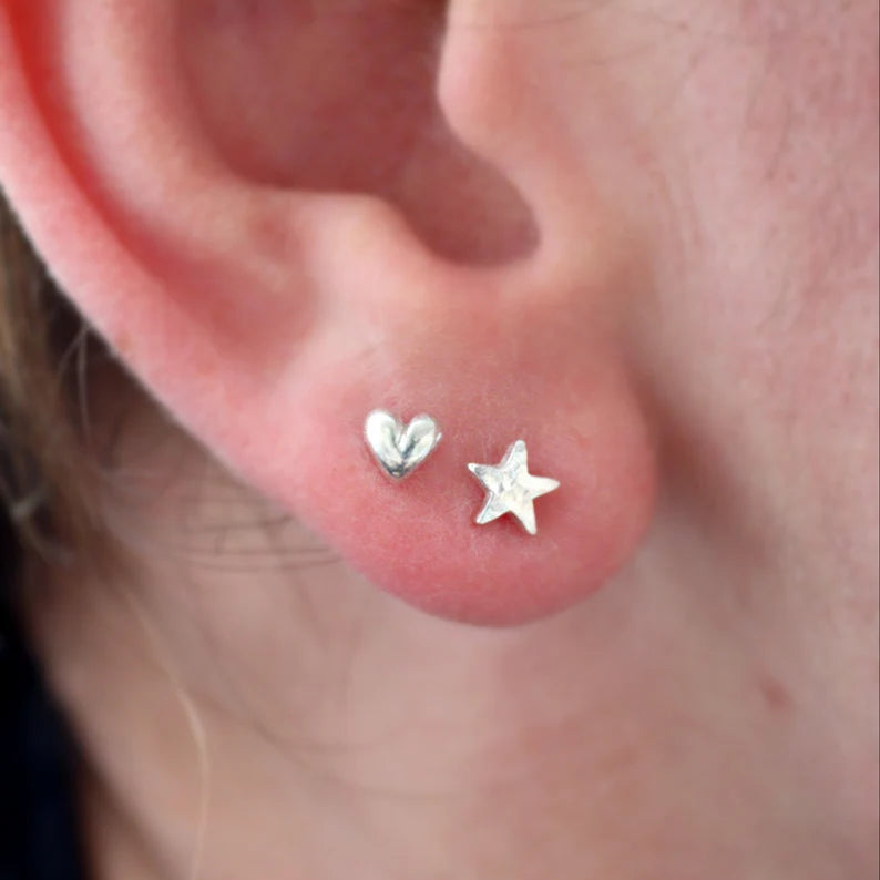 Tiny Silver Heart Stud worn with a matching size silver star stud in the first and second piercing.