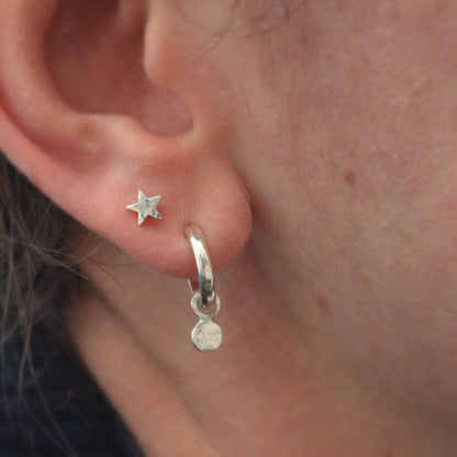 Tiny star studs worn in a second piercing next to my confetti hoops.