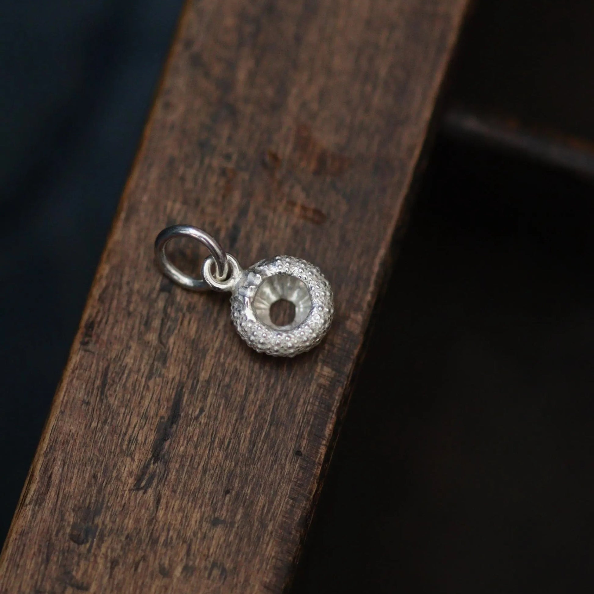 the back of a silver sea urchin pendant showing the detail all around