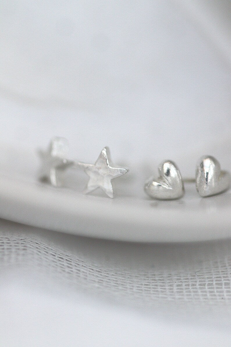 silver heart studs shown next to similar scale silver star studs
