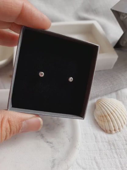 Silver personalised initial stud earrings in a grey jewellery box