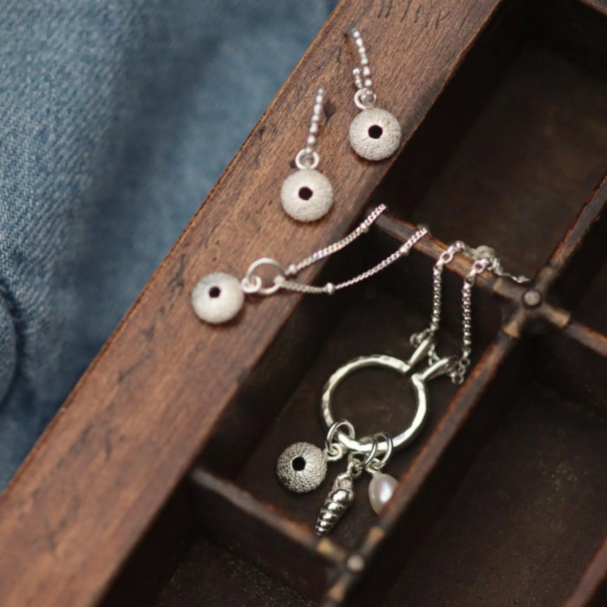 a collection of handmade sea urchin jewellery in a letterpress drawer