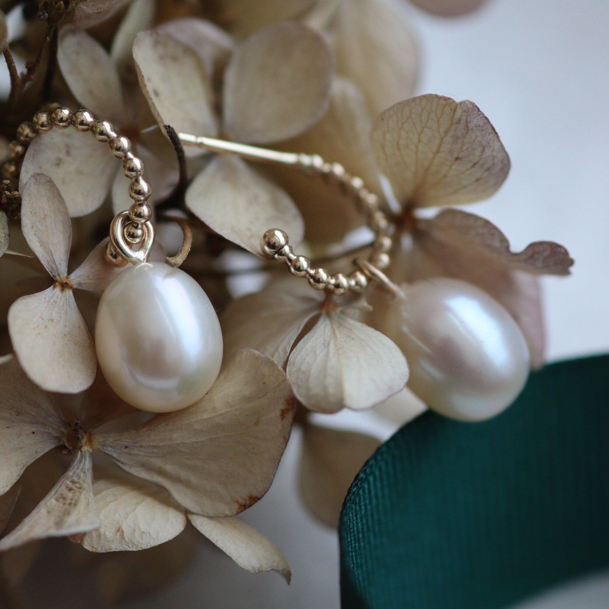 large pearl drop gold hoop earrings in a hydrangea flower head