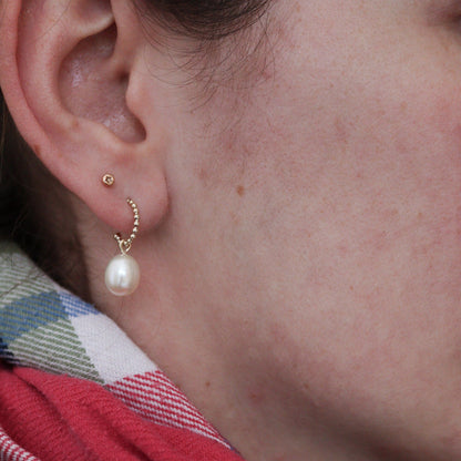 large pearl drop gold earrings with a beaded texture