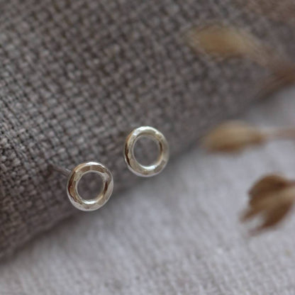silver circle studs with a hammered texture.