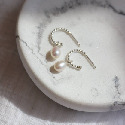 Small silver beaded design hoops with small pearl drops.