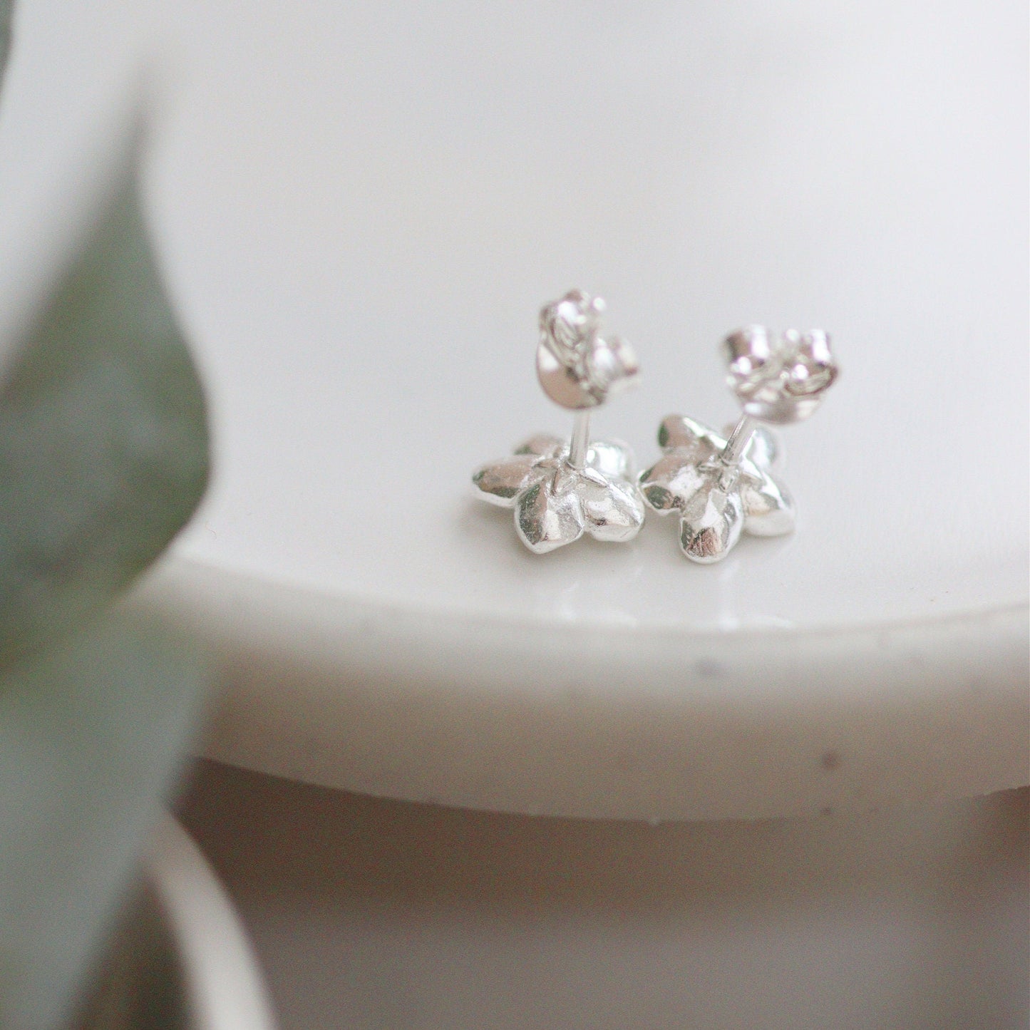 the back of the forget-me-not studs with a star carved in the back. showing the posts and butterflies.