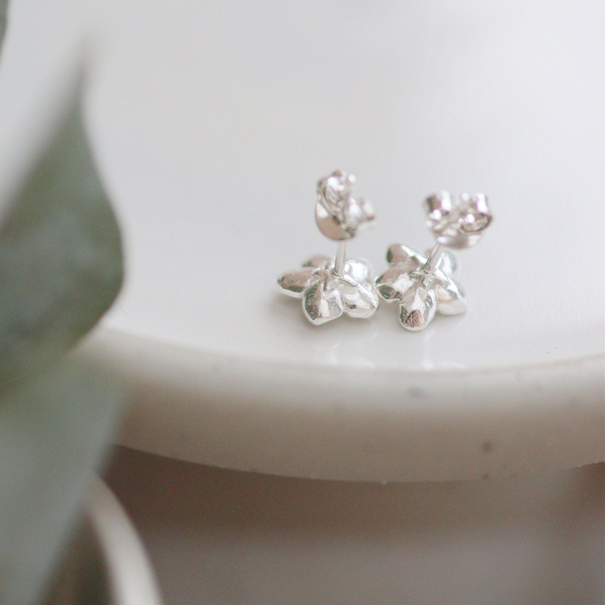 the back of the forget-me-not studs with a star carved in the back. showing the posts and butterflies.